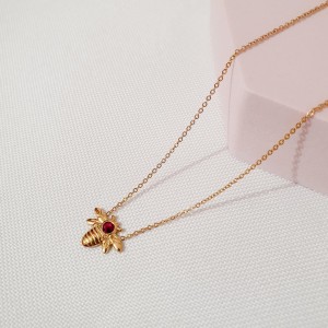 Naszyjnik złoty bączek, muszka, stal pozłacana